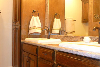 Example of a mid-sized classic master beige tile and porcelain tile porcelain tile bathroom design in Austin with a drop-in sink, raised-panel cabinets, dark wood cabinets, granite countertops, a two-piece toilet and beige walls