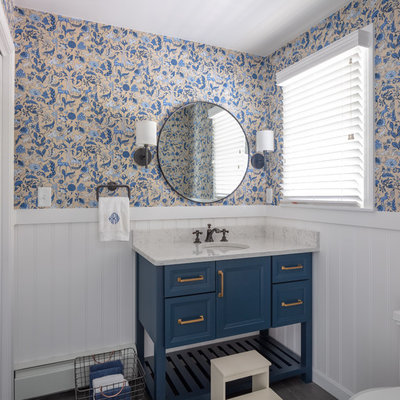 Inspiration for a coastal bathroom remodel in Boston with furniture-like cabinets, blue cabinets, multicolored walls, an undermount sink and white countertops