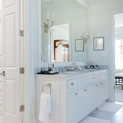 Inspiration for a large timeless master gray tile, white tile and stone tile marble floor drop-in bathtub remodel in Dallas with raised-panel cabinets, white cabinets, a one-piece toilet, white walls, an undermount sink and marble countertops