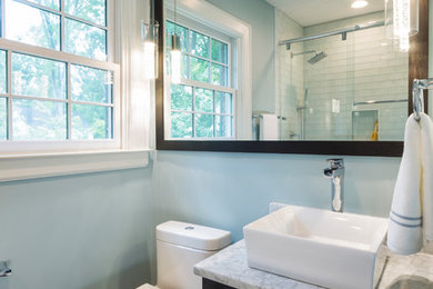 Small transitional kids' white tile and glass tile ceramic tile and gray floor bathroom photo in Charlotte with flat-panel cabinets, dark wood cabinets, a one-piece toilet, blue walls, a vessel sink and marble countertops