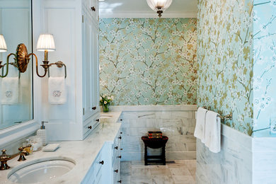 Example of a mid-sized classic marble floor bathroom design in Nashville with marble countertops, an undermount sink, white cabinets and multicolored walls