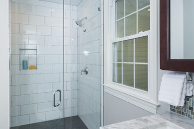 Large transitional master white tile and ceramic tile ceramic tile and gray floor walk-in shower photo in Charlotte with recessed-panel cabinets, dark wood cabinets, a two-piece toilet, gray walls, an undermount sink, marble countertops and a hinged shower door