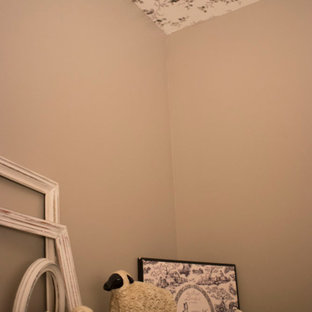Inspiration for a small cottage 3/4 dark wood floor, brown floor, single-sink and wallpaper ceiling bathroom remodel in Grand Rapids with furniture-like cabinets, brown cabinets, a one-piece toilet, beige walls, an undermount sink, granite countertops, black countertops and a built-in vanity