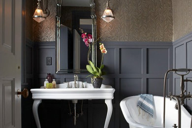 Mid-sized ornate 3/4 laminate floor claw-foot bathtub photo in Boston with gray walls and a console sink