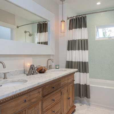 Example of a transitional white tile and stone tile bathroom design in Orange County with an undermount sink, medium tone wood cabinets, flat-panel cabinets and marble countertops