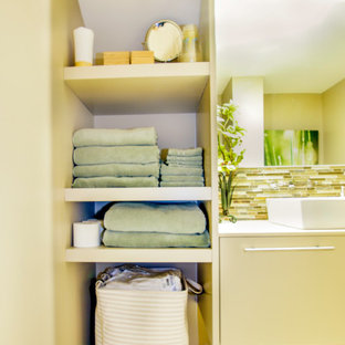 Photo of a small contemporary 3/4 bathroom in St Louis with flat-panel cabinets, beige cabinets, an alcove shower, a two-piece toilet, multi-coloured tile, mosaic tile, beige walls, porcelain floors, a vessel sink, onyx benchtops, multi-coloured floor, a hinged shower door, white benchtops, a shower seat, a single vanity and a floating vanity.