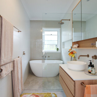Photo of a contemporary master bathroom in Sydney with flat-panel cabinets, medium wood cabinets, a freestanding tub, a curbless shower, beige tile, a vessel sink, beige floor, an open shower, white benchtops, a niche, a single vanity and a floating vanity.