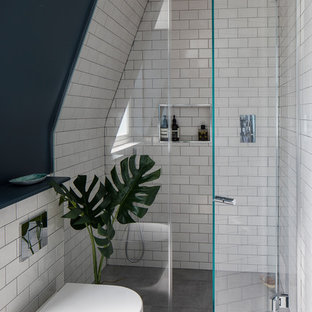 Esempio di una piccola stanza da bagno padronale contemporanea con doccia aperta, WC sospeso, piastrelle bianche, piastrelle in ceramica, pavimento in cementine, pavimento grigio, porta doccia a battente e pareti nere