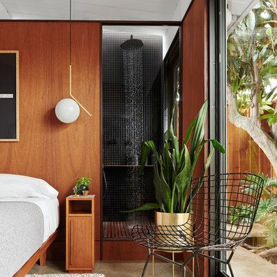 Example of a small trendy master black tile and ceramic tile concrete floor and gray floor bathroom design in San Francisco with flat-panel cabinets, medium tone wood cabinets, a wall-mount toilet, black walls and a pedestal sink