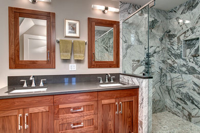 Design ideas for a traditional ensuite bathroom in Seattle with shaker cabinets, medium wood cabinets, a walk-in shower, grey tiles, stone tiles, beige walls, a submerged sink and engineered stone worktops.