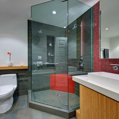 Corner shower - small modern 3/4 mosaic tile and red tile porcelain tile and gray floor corner shower idea in San Francisco with a vessel sink, open cabinets, a two-piece toilet, white walls, a hinged shower door, light wood cabinets and quartz countertops
