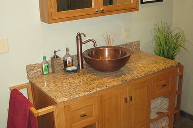 Example of an asian 3/4 slate floor and brown floor bathroom design in Other with shaker cabinets, light wood cabinets, gray walls, a vessel sink and granite countertops
