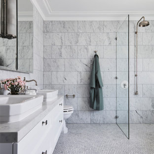 Photo of a transitional master bathroom in Newcastle - Maitland with recessed-panel cabinets, white cabinets, a curbless shower, marble, grey walls, a vessel sink, marble benchtops, an open shower, grey benchtops, a double vanity and a floating vanity.