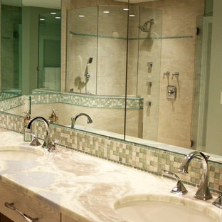 Example of a mid-sized beach style master beige tile and ceramic tile ceramic tile and beige floor bathroom design in Miami with shaker cabinets, medium tone wood cabinets, a one-piece toilet, beige walls, an undermount sink, quartzite countertops and a hinged shower door