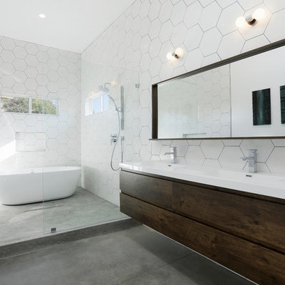 Bathroom - contemporary master white tile concrete floor and gray floor bathroom idea in Los Angeles with flat-panel cabinets, dark wood cabinets, white walls, an integrated sink and white countertops