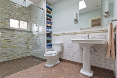 Example of a classic walk-in shower design in New York with a pedestal sink