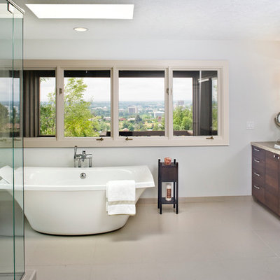 Inspiration for a large contemporary master multicolored tile and glass tile ceramic tile bathroom remodel in Boise with a drop-in sink, flat-panel cabinets, dark wood cabinets, limestone countertops and gray walls