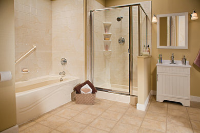 Example of a master beige tile and stone tile bathroom design in Chicago with louvered cabinets, white cabinets, beige walls, an integrated sink, a hinged shower door and white countertops