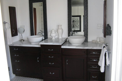 Inspiration for a mid-sized timeless bathroom remodel in Other with a vessel sink, raised-panel cabinets, dark wood cabinets and laminate countertops