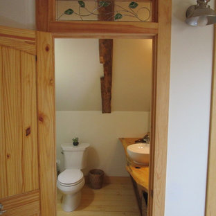 Bathroom - small craftsman brown floor bathroom idea in Portland Maine with light wood cabinets, a two-piece toilet, multicolored walls, a vessel sink and wood countertops