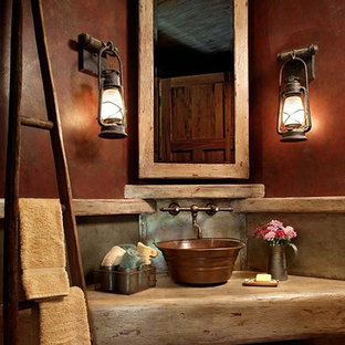 This is an example of a traditional bathroom in Other with concrete benchtops and red walls.