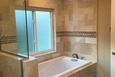 Mid-sized transitional master beige tile and travertine tile vinyl floor and brown floor bathroom photo in Tampa with beige walls and a hinged shower door