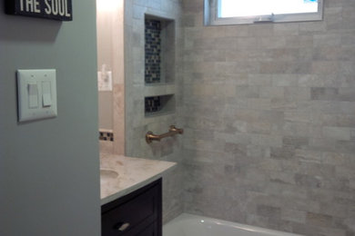 Bathroom - small gray tile and porcelain tile porcelain tile bathroom idea in New York with an undermount sink, furniture-like cabinets, dark wood cabinets, marble countertops, a two-piece toilet and gray walls