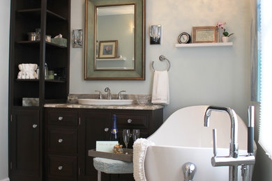 Example of a mid-sized transitional master multicolored tile and porcelain tile porcelain tile bathroom design in Baltimore with a drop-in sink, furniture-like cabinets, dark wood cabinets, quartzite countertops, a one-piece toilet and blue walls