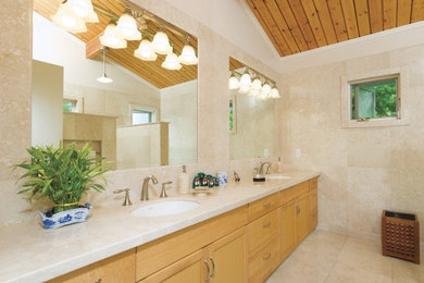 Example of a minimalist bathroom design in Hawaii with an undermount sink, shaker cabinets, light wood cabinets and white walls