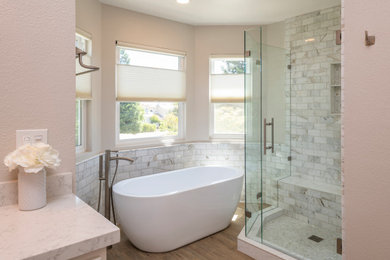 Trendy master gray tile and marble tile porcelain tile, brown floor and double-sink bathroom photo in San Francisco with white cabinets, beige walls, an undermount sink, quartz countertops, a hinged shower door, white countertops and a built-in vanity