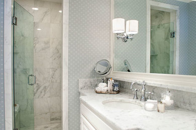 Inspiration for a mid-sized transitional master marble floor corner shower remodel in St Louis with beaded inset cabinets, white cabinets, a one-piece toilet, gray walls, an undermount sink and marble countertops
