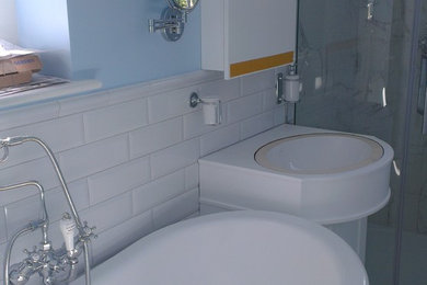 This is an example of a medium sized victorian bathroom in West Midlands with a claw-foot bath, a corner shower, a wall mounted toilet, white tiles, ceramic tiles, blue walls, ceramic flooring and a console sink.