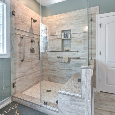 Inspiration for a coastal master beige tile and porcelain tile porcelain tile and beige floor bathroom remodel in Charleston with raised-panel cabinets, dark wood cabinets, a two-piece toilet, blue walls, an undermount sink, granite countertops, a hinged shower door and beige countertops