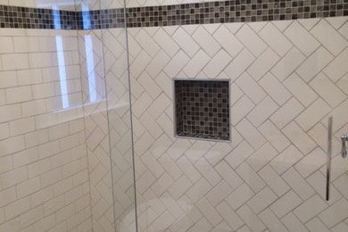 Example of a small trendy beige tile and porcelain tile porcelain tile double shower design in New York with an undermount sink, raised-panel cabinets, medium tone wood cabinets, granite countertops, a two-piece toilet and beige walls