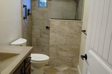 This is an example of a medium sized traditional shower room bathroom in Other with dark wood cabinets, a walk-in shower, a two-piece toilet, multi-coloured tiles, porcelain tiles, beige walls, vinyl flooring, an integrated sink, concrete worktops, an open shower, grey worktops, shaker cabinets and beige floors.