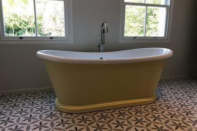 Inspiration for a vintage ensuite bathroom in London with a freestanding bath and ceramic flooring.