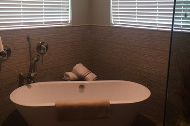 Example of a mid-sized transitional master brown tile and porcelain tile dark wood floor and brown floor bathroom design in Orlando with shaker cabinets, dark wood cabinets, a two-piece toilet, green walls, an undermount sink, granite countertops and a hinged shower door