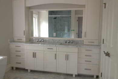 Inspiration for a large transitional master marble floor and multicolored floor alcove shower remodel in Toronto with shaker cabinets, white cabinets, gray walls, an undermount sink, marble countertops and a hinged shower door