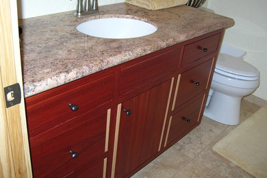 Inspiration for a beige tile bathroom remodel in San Francisco with medium tone wood cabinets