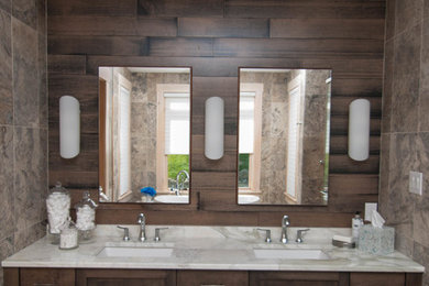 Inspiration for a mid-sized modern master gray tile and stone tile ceramic tile and brown floor bathroom remodel in Other with an undermount sink, furniture-like cabinets, medium tone wood cabinets, quartzite countertops, a one-piece toilet and gray walls