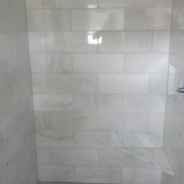 BATHROOM - Calcutta Gold Marble Shower / Gray Penny Tile Floor