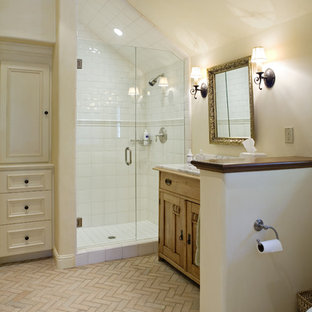 This is an example of a country bathroom in Other with a corner shower and brick floors.