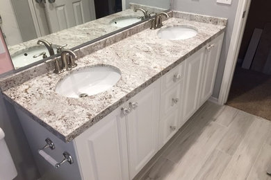Inspiration for a mid-sized transitional bathroom remodel in Houston with beaded inset cabinets and white cabinets