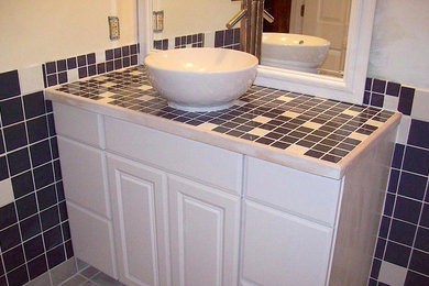 Mid-sized transitional multicolored tile and ceramic tile ceramic tile and beige floor bathroom photo in Grand Rapids with a vessel sink, raised-panel cabinets, an urinal, white cabinets and multicolored walls