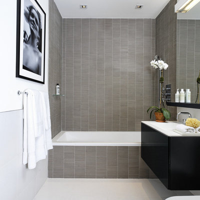 Inspiration for a contemporary gray tile and mosaic tile bathroom remodel in New York with flat-panel cabinets, black cabinets and white countertops