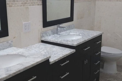 Klassisches Badezimmer En Suite mit flächenbündigen Schrankfronten, schwarzen Schränken und Unterbauwaschbecken in Tampa
