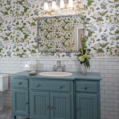 Inspiration for a tropical white tile and subway tile mosaic tile floor, gray floor and single-sink bathroom remodel in Miami with shaker cabinets, blue cabinets, multicolored walls, a drop-in sink, wood countertops, blue countertops and a freestanding vanity