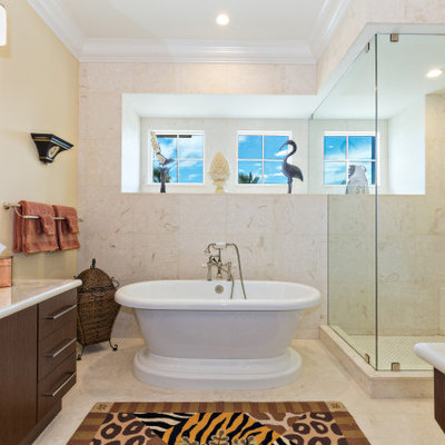 Example of an island style beige tile beige floor and single-sink bathroom design in Miami with flat-panel cabinets, dark wood cabinets, a vessel sink, white countertops and a built-in vanity