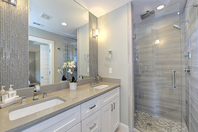 Alcove shower - mid-sized transitional 3/4 gray tile and ceramic tile porcelain tile and beige floor alcove shower idea in Orange County with shaker cabinets, white cabinets, gray walls, an undermount sink, quartz countertops, a hinged shower door and gray countertops