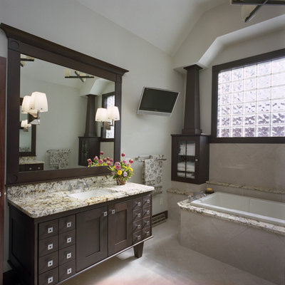 Example of a large trendy master beige tile and ceramic tile ceramic tile drop-in bathtub design in Other with granite countertops, shaker cabinets, dark wood cabinets, beige walls and an undermount sink